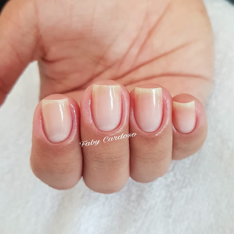 Unhas com cutilagem e esmaltação nude bem-feitas